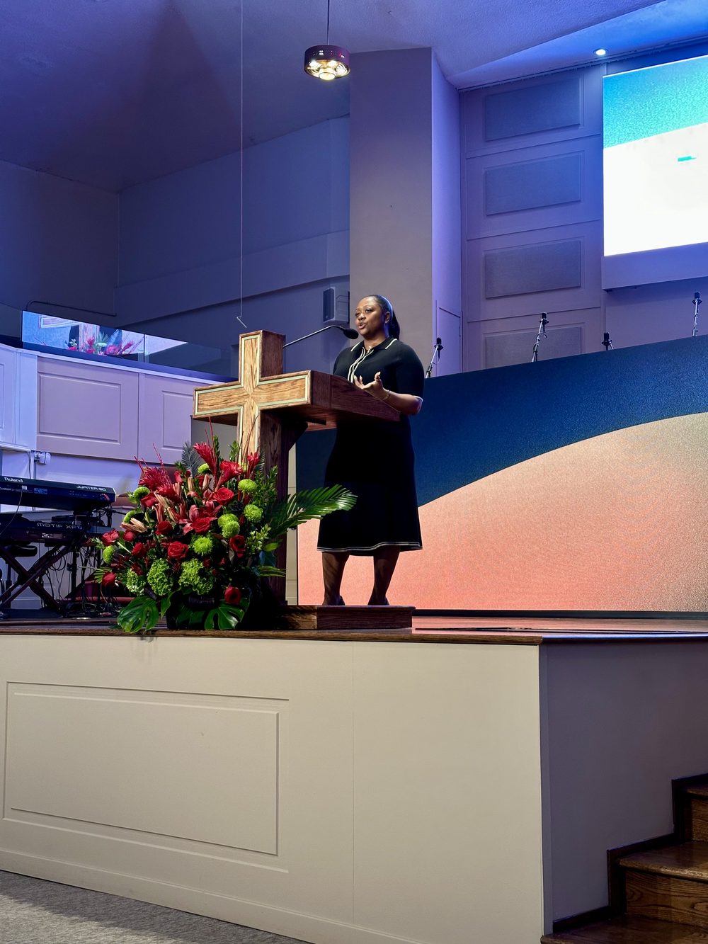 Hunter Guy speaking from a pulpit to a congregation.